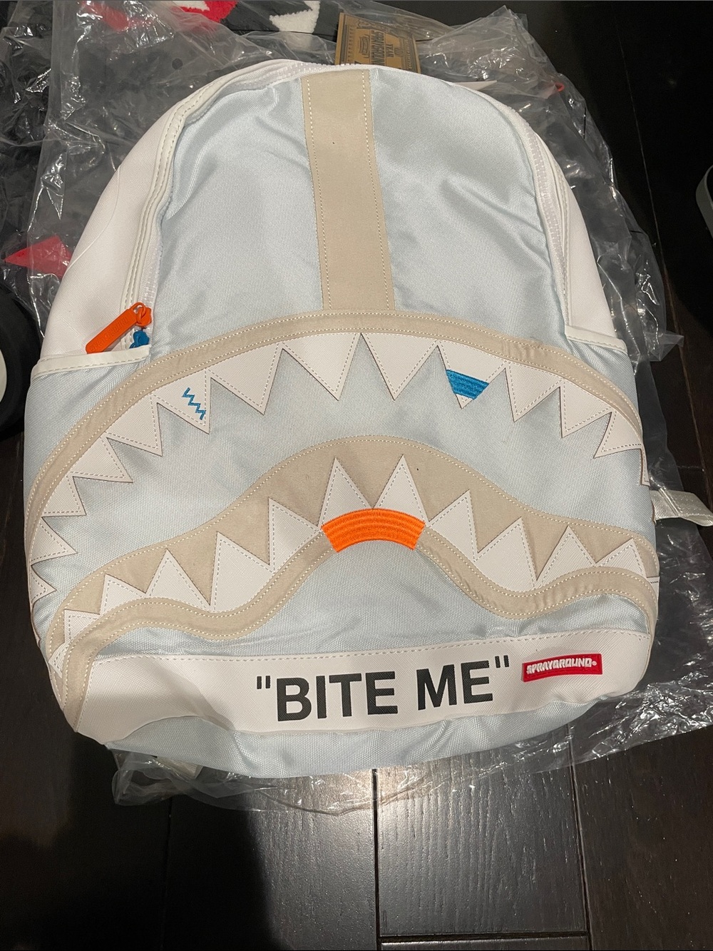 Sprayground Light Gray & Beige Shark-Mouth Backpack with Orange Accents